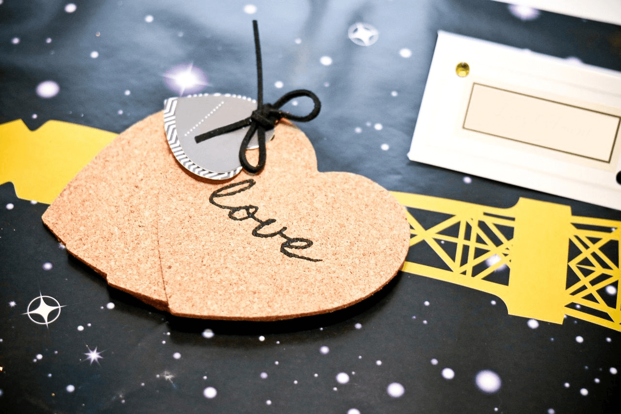Handmade love tags and printable craft materials arranged on a patterned table